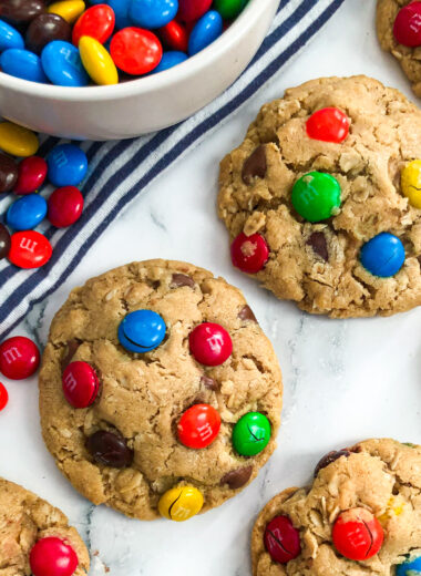 close up photo of monster cookies with a bowl of M&M's on the side
