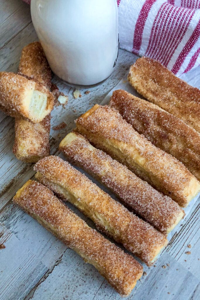easy baked churros with a glass of milk for serving