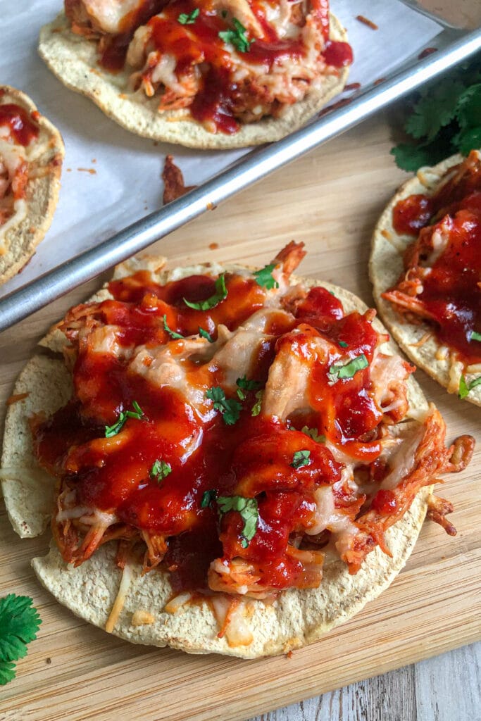 BBQ chicken tostadas on a serving platter with chopped cilantro for garnish