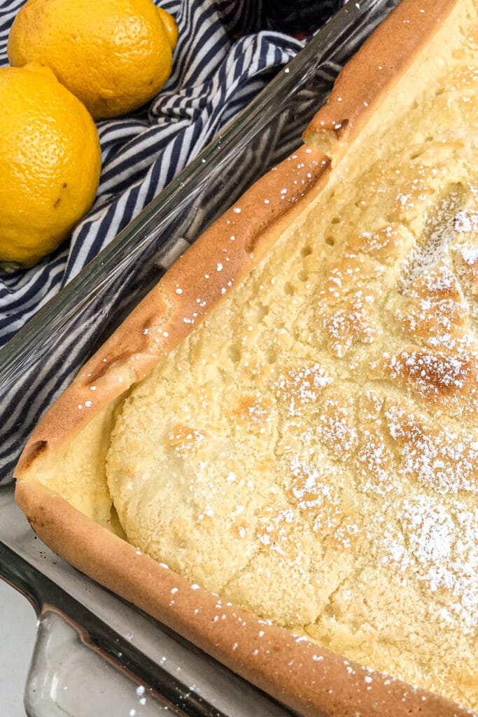 German pancakes in a baking dish with lemons on the side for a garnish