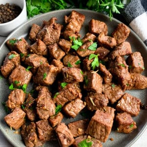 Garlic butter steak bites on a plate.