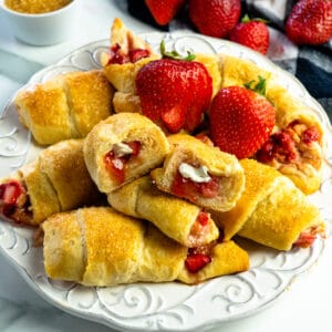 Close up of strawberry cheesecake crescent rolls cut in half to show off the filling.