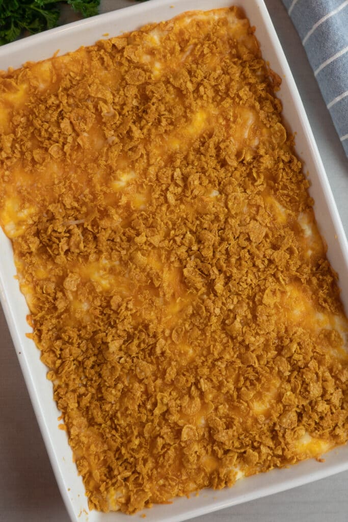Amish funeral potatoes in a white baking dish to show off the cornflake crust.