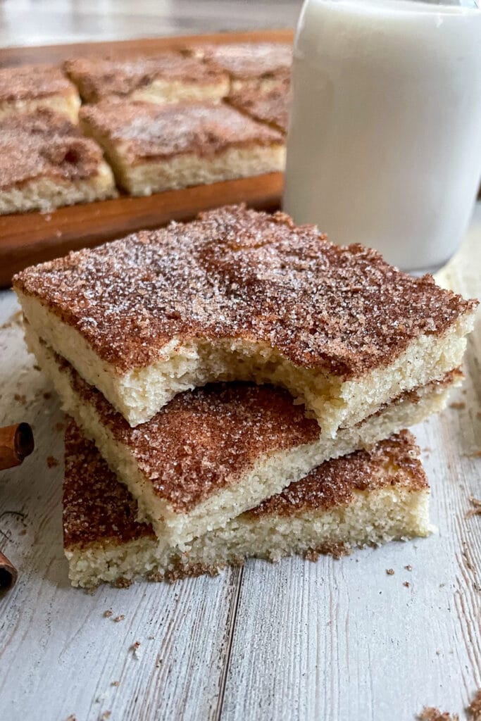Snickerdoodle cookie bars served with a glass of milk