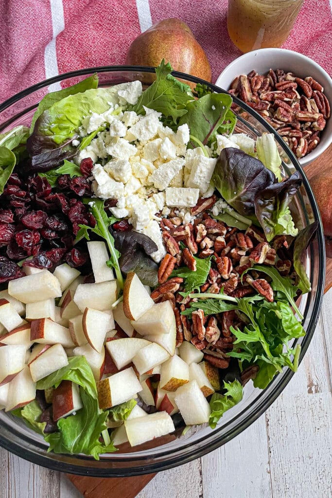 Ingredients for autumn pear salad served in a large mixing bowl