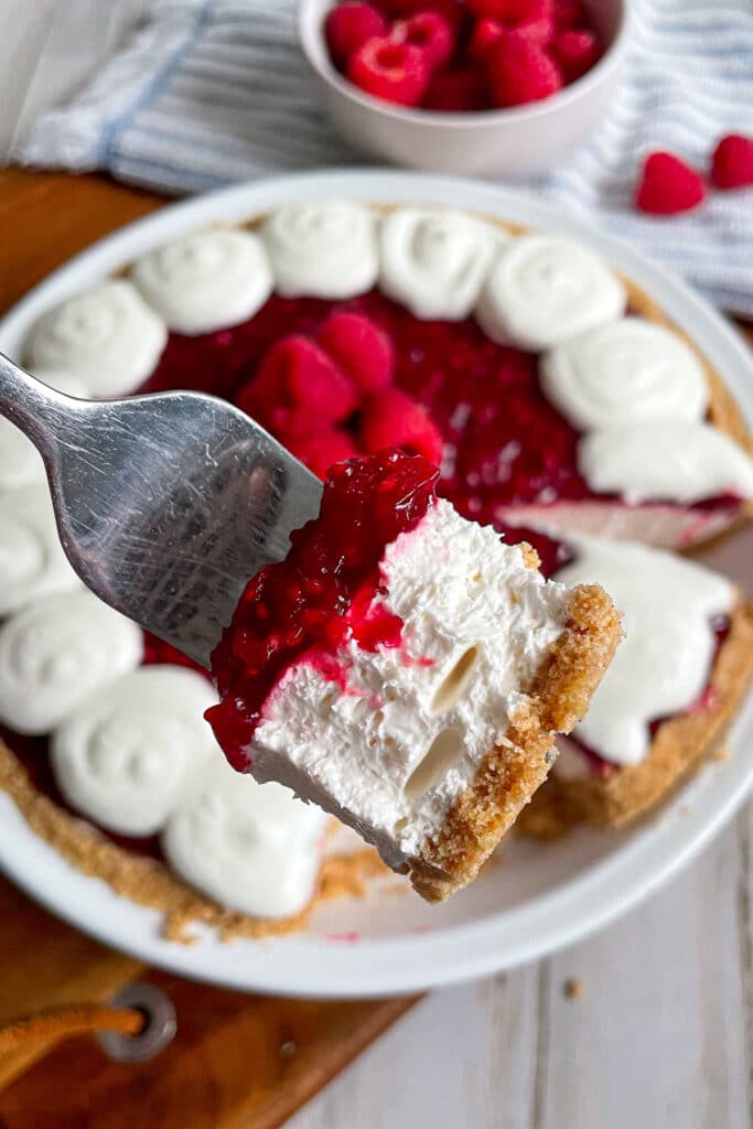 close up of raspberry cream pie on a fork
