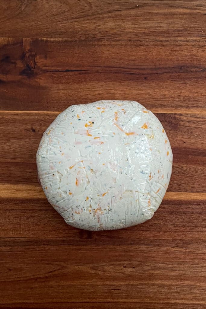 cheese ball wrapped in saran wrap to be chilled