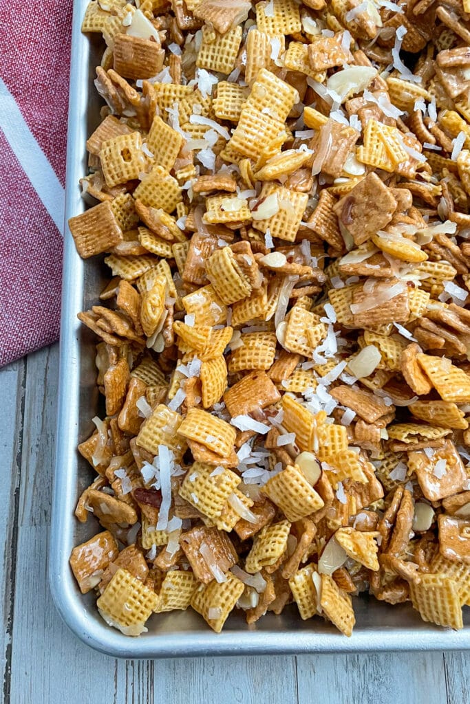 Coconut almond chex mix cooling on a sheet pan