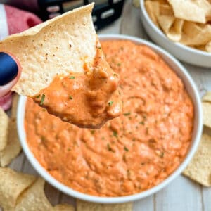 easy cream cheese taco dip served in a white dish with chips for serving