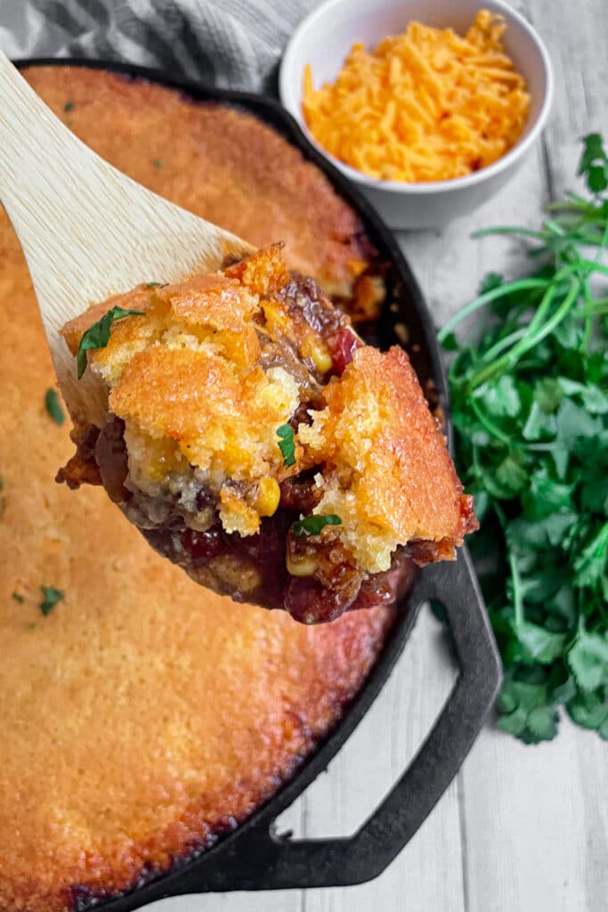 Close up shot of a spoonful of cornbread chili pie