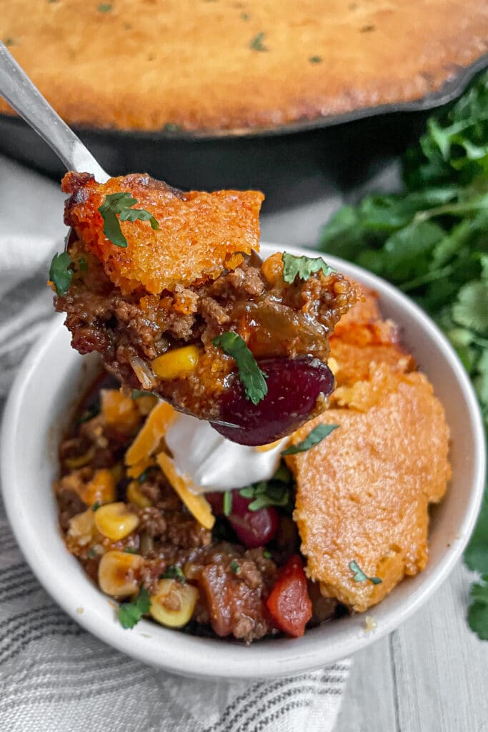 close up photo of cornbread chili pie on a spoon