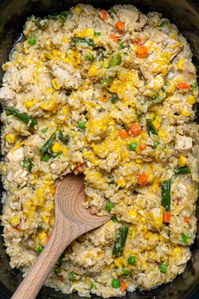 Close up of crock pot chicken and rice in a slow cooker.