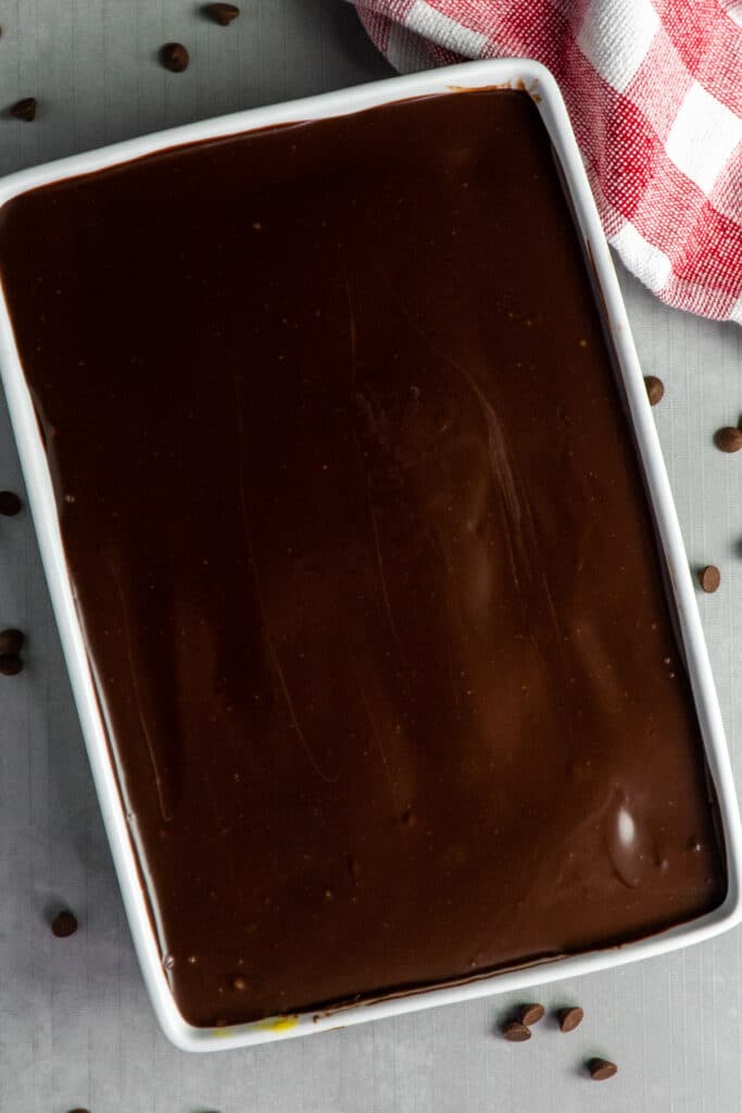 Overhead look at a cake with chocolate frosting on top.