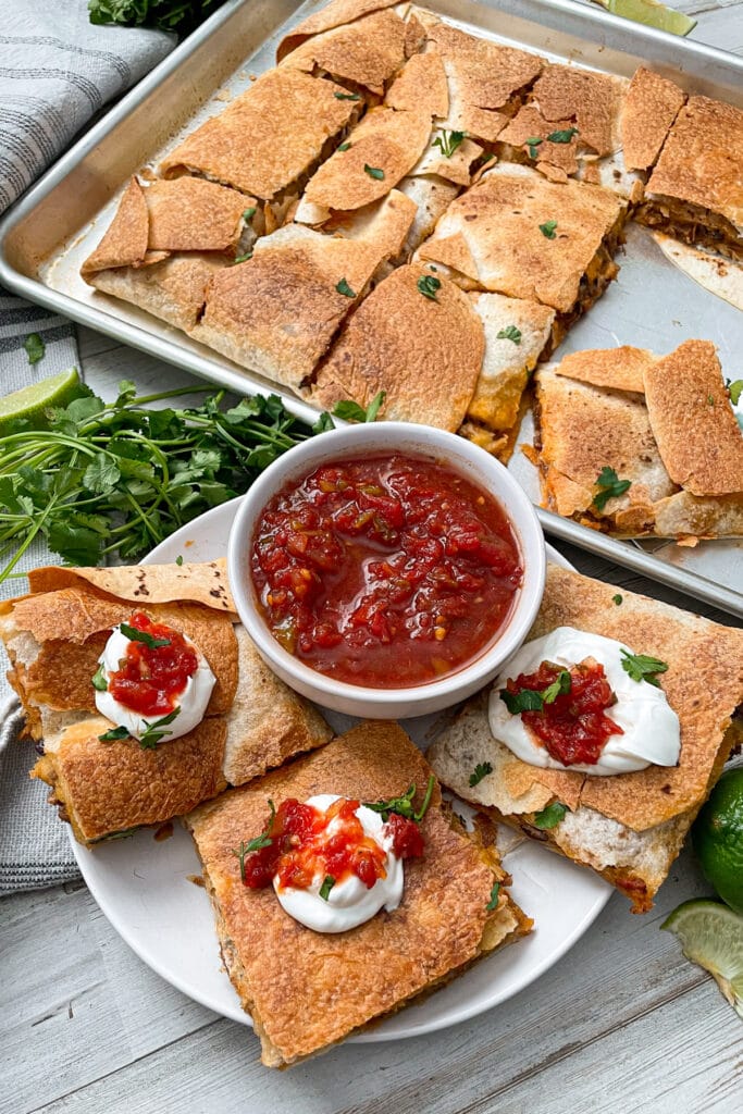 Sheet pan quesadillas served with salsa and sour cream