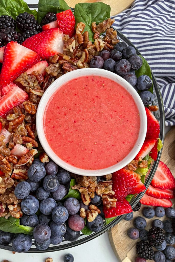 mixed berry salad with candied pecans and strawberry vinaigrette