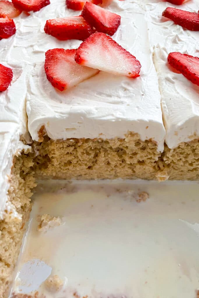 Tres Leches cake with 2 slices taken out of it