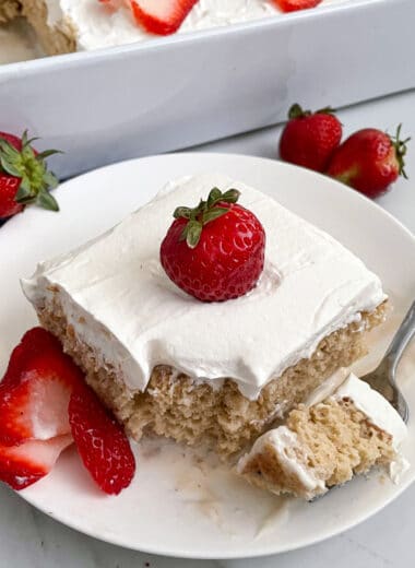 close up photo of Tres Leches cake topped with strawberries