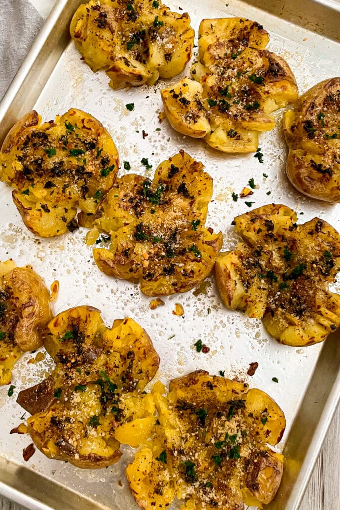 easy garlic parmesan smashed potatoes garnished with fresh parsley