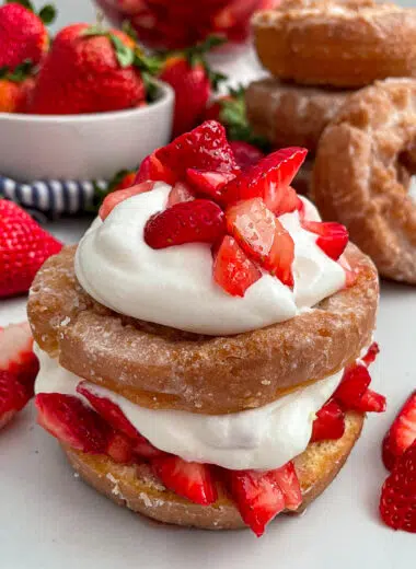 Close up shot of strawberry shortcake donut with strawberries on the side