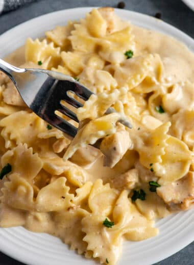 Close up of Instant Pot chicken alfredo on a fork.