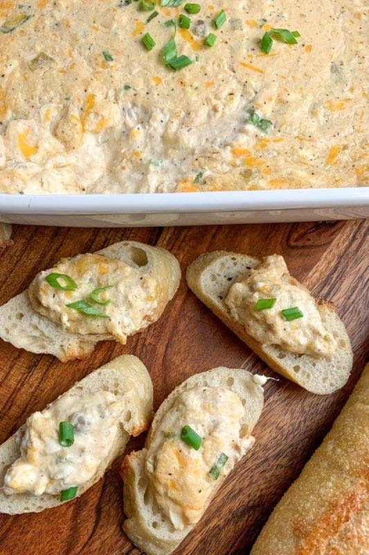 Hot cheesy crab dip on top of 4 slices of baguette.