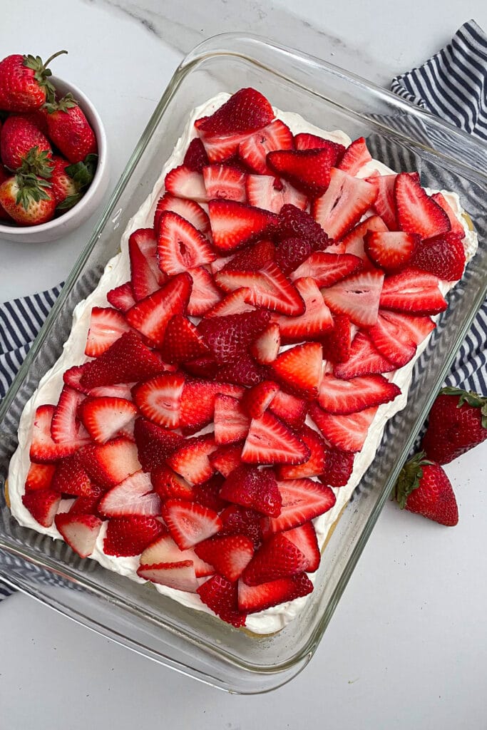 baked strawberry shortcake dessert bars topped with strawberries