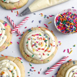 close up photo of crumble birthday cake cookies with sprinkles, candles, and frosting