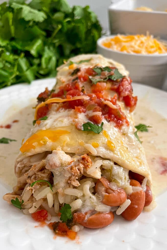 smothered honey lime chicken burritos on a serving plate