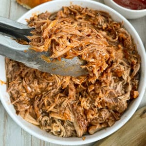 close up photo of dr pepper pulled pork in a serving bowl