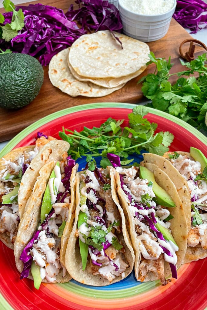 Easy fish tacos served on a plate with toppings on the side