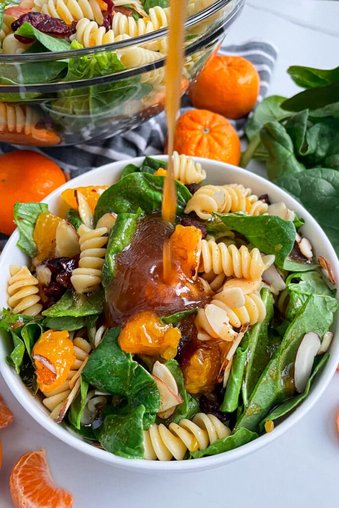 mandarin spinach pasta salad with dressing on top