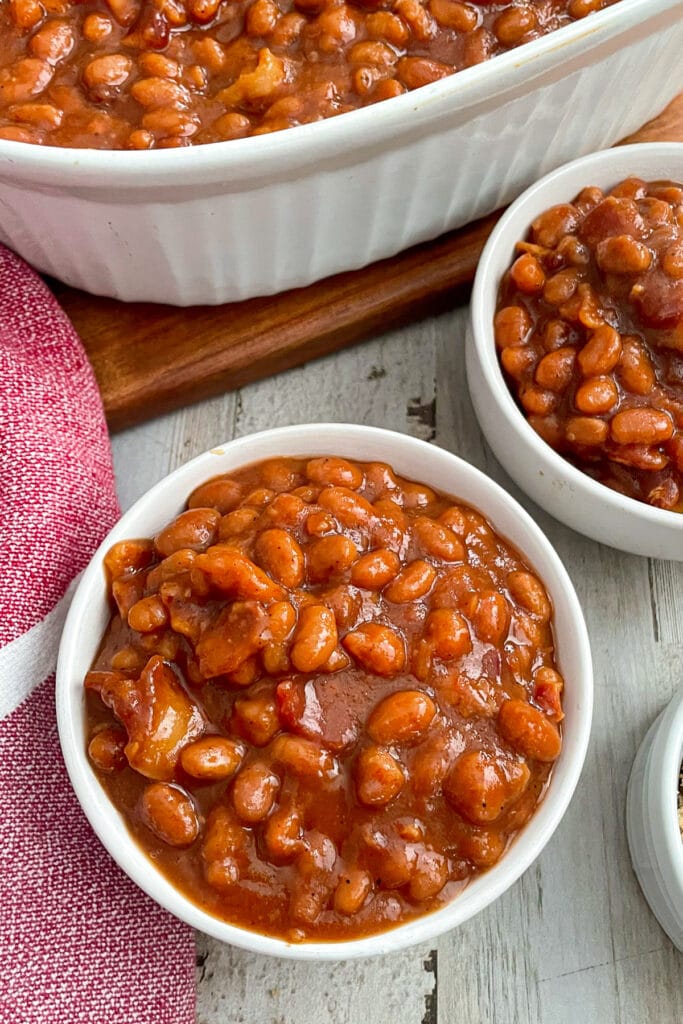best baked beans in serving bowls with a red dish rag