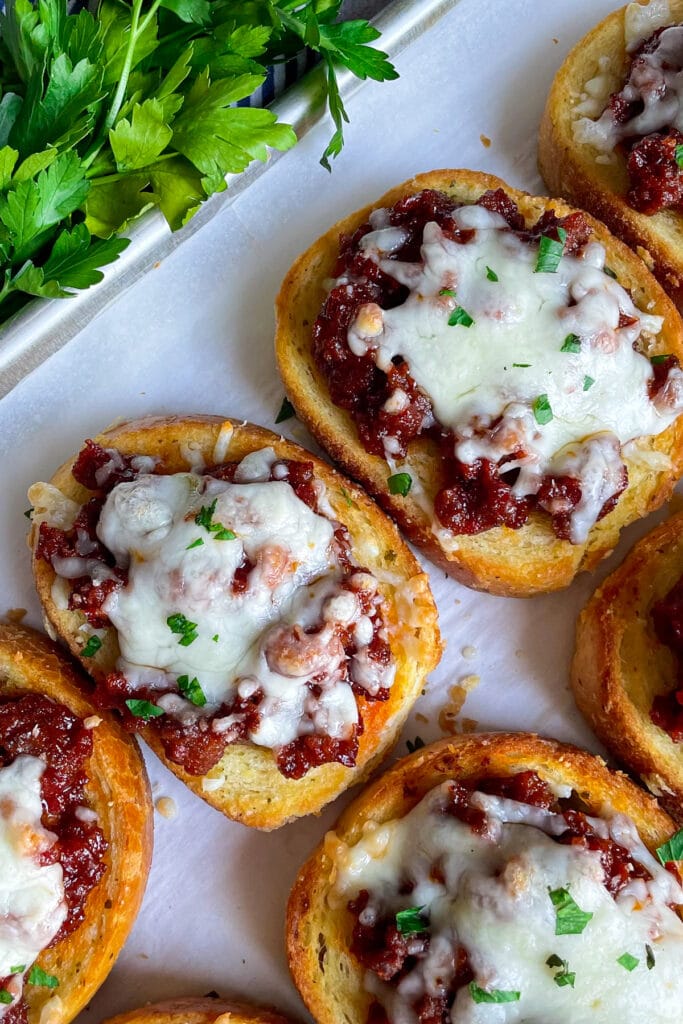 Easy Texas Toast Sloppy joes topped with mozzarella cheese and parsley baked on a sheet pan