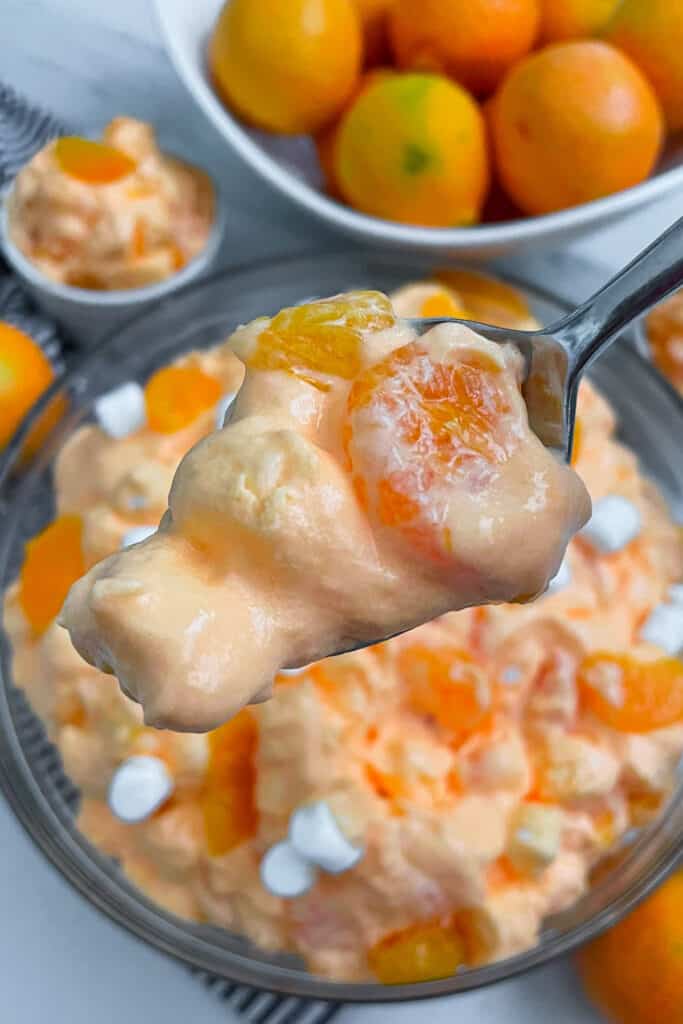 close up shot of orange creamsicle fluff salad on a fork
