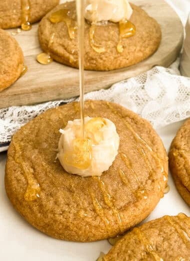 photo of copycat Crumbl cornbread cookies topped with a dollop of honey butter and drizzled with honey