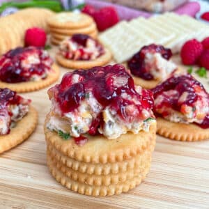 Easy Pepper Jelly Cheese spread topped on stacked crackers.