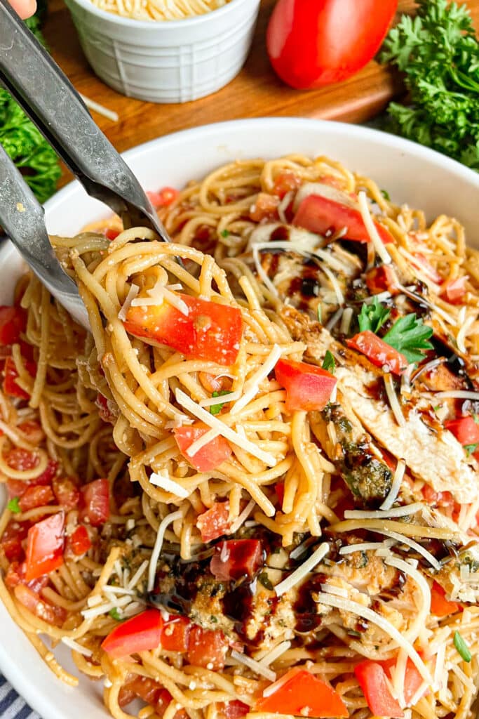 Best Bruschetta pasta in a white serving bowl topped with balsamic glaze