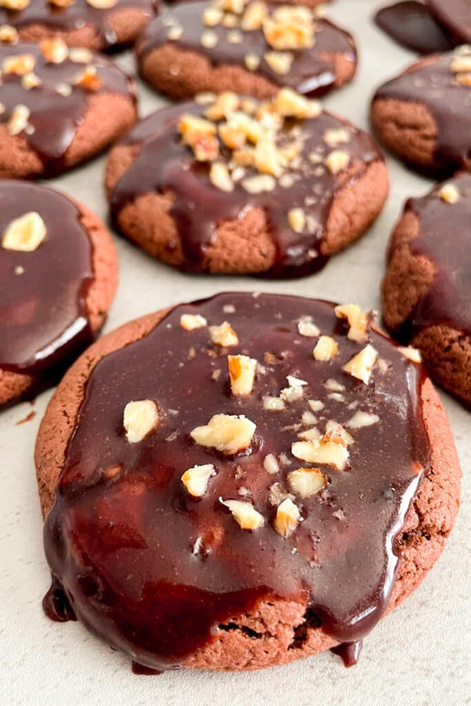 close up shot of texas sheet cake cookies topped with chopped pecans
