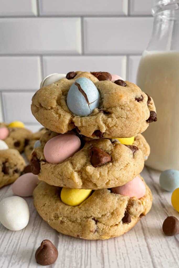 The best Cadbury egg cookies stacked on top of each other. Milk in the background