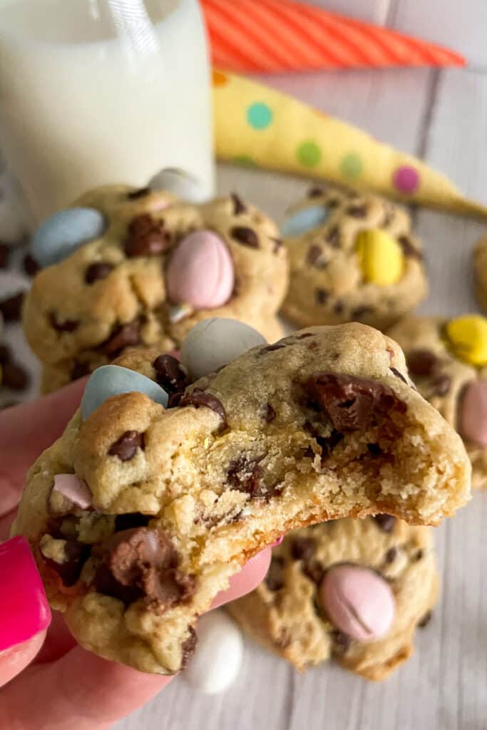 close up shot of a cadbury egg cookie with a bite taken out of it.