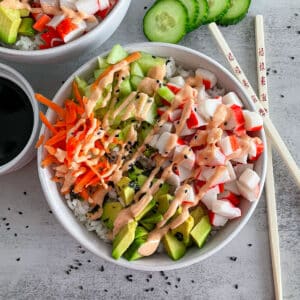 Easy California Roll Sushi Bowl with chopsticks on the side of the bowl for serving.