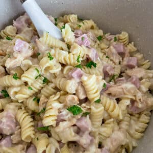 close up shot of easy one pot creamy chicken cordon bleu with a serving spoon