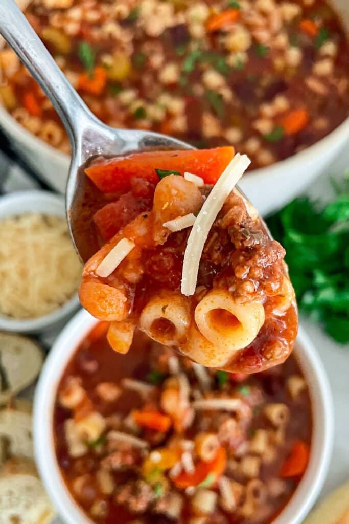 close up shot of soup olive gardens pasta e fagioli soup on a spoon for eating.
