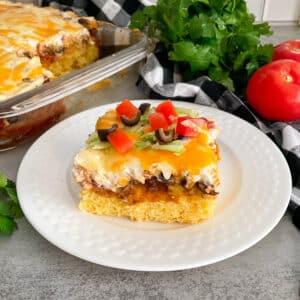 Mexican cornbread casserole on a white serving plate