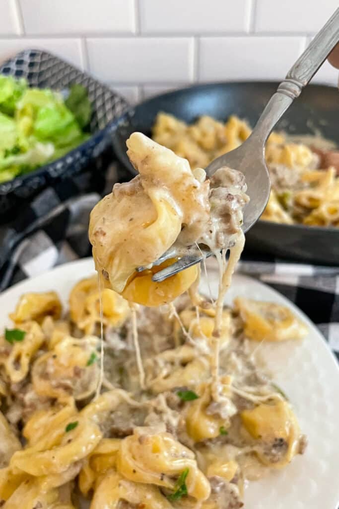 Close up shot of Philly cheesesteak tortellini on a fork for eating