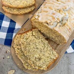 almond poppyseed bread on a cutting board. Slices of bread for serving.