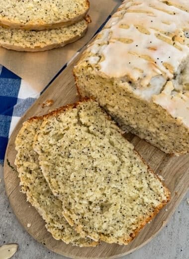 almond poppyseed bread on a cutting board. Slices of bread for serving.