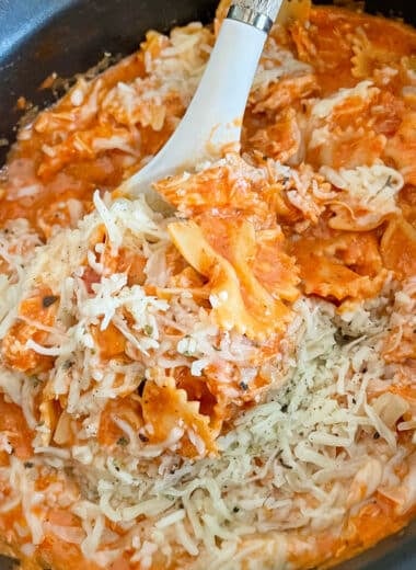 slow cooker Italian chicken pasta in a slow cooker with a large spoon taking a portion out of the crock pot