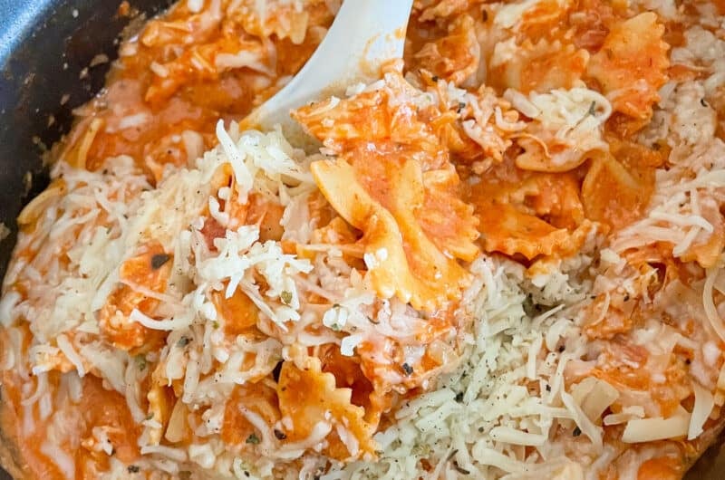 slow cooker Italian chicken pasta in a slow cooker with a large spoon taking a portion out of the crock pot