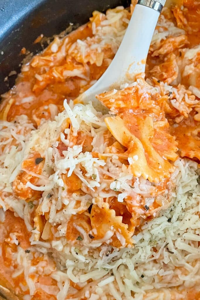 slow cooker Italian chicken pasta in a slow cooker with a large spoon taking a portion out of the crock pot